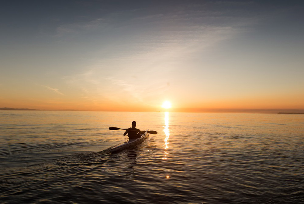 kayaking into the sunset on an Aussie Watersports rental